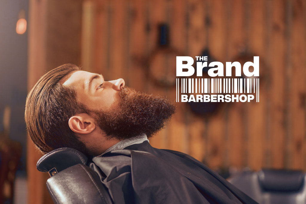 Just relax. Handsome man sitting half turned in the armchair in the barbershop